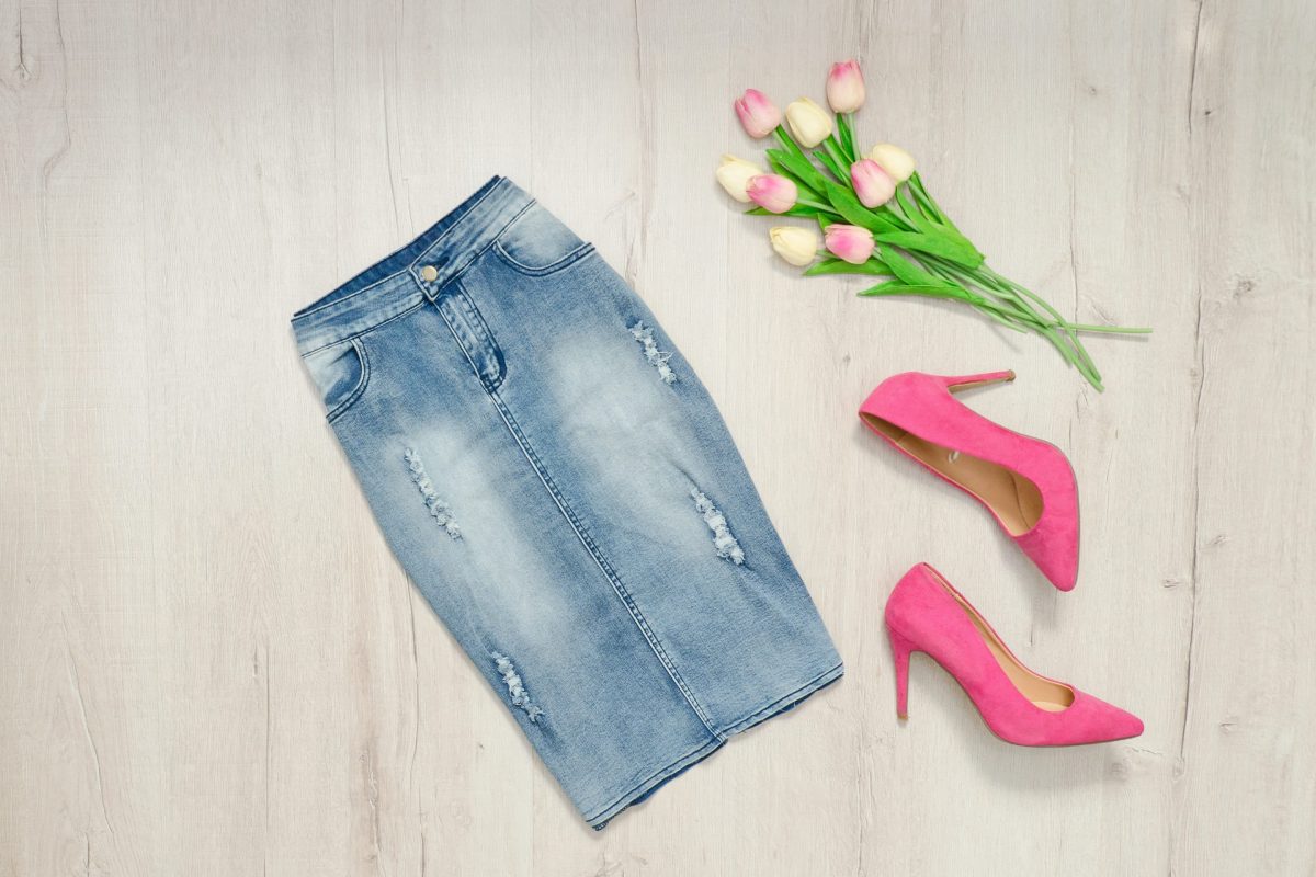 Blue denim skirt, pink shoes and bouquet of tulips. Fashionable concept